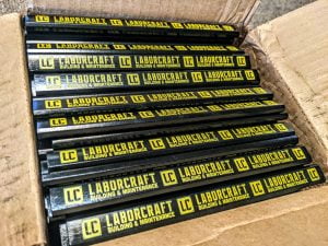 A box of black carpenter pencils with yellow lettering that says Laborcraft Building & Maintenance