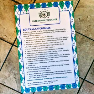 Large sign with Green and Blue design by edges. The Rules for the Golf Simulator are in the middle with contact info at the bottom.