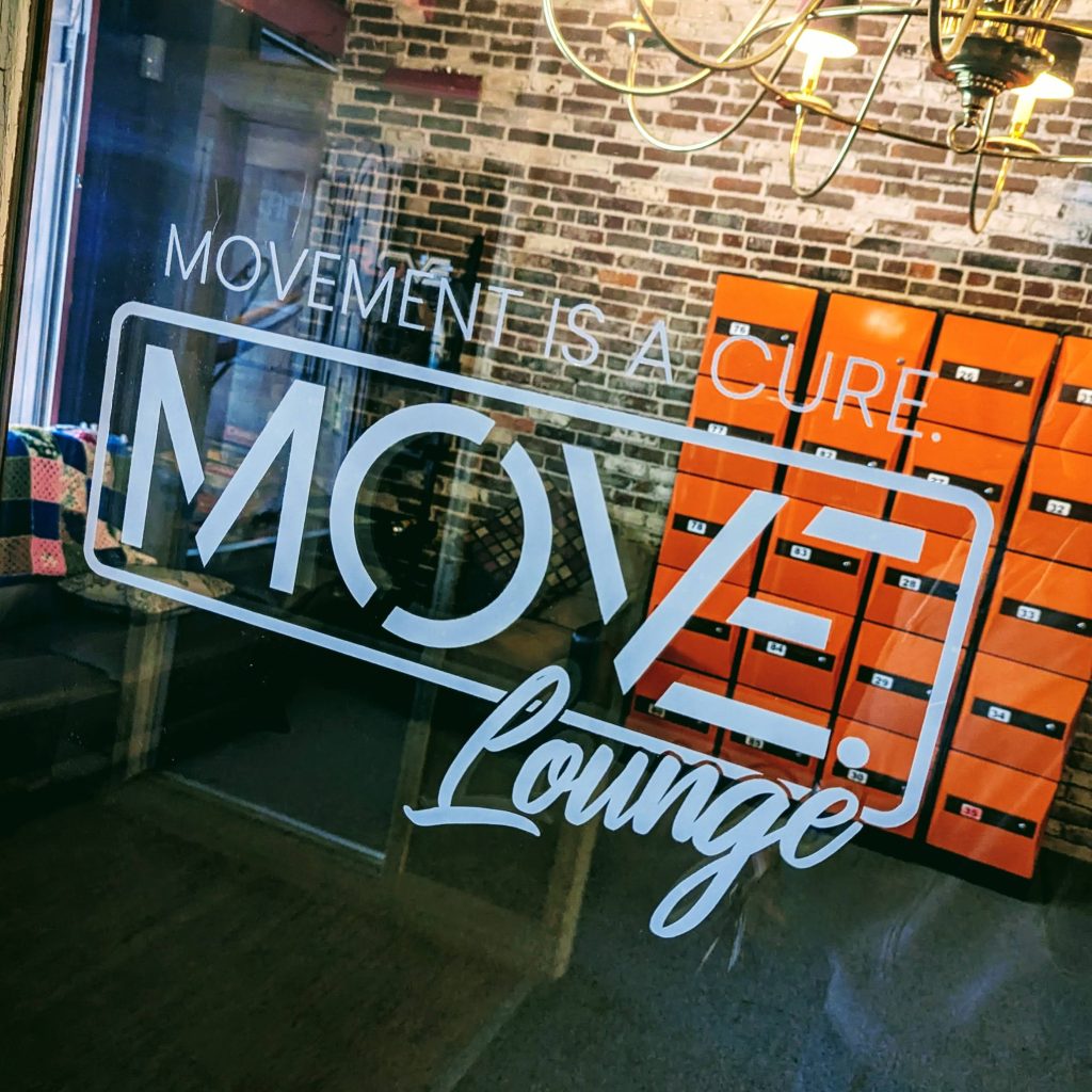 White lettering with the log for Move Lounge on a door.   