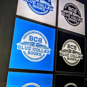 Variations of the same logo for Blue Collar books. Several blocks showcasing the variations. One is on a white with blue logo in the middle, white with black logo in the middle, blue with white logo and black with white logo