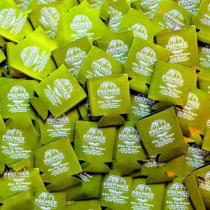 Green koozies with the name of business and contact information