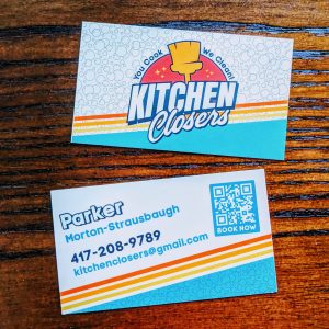 Colorful with retro shades one side has the Kitchen Closers logo and the other side has the contact information for the business.