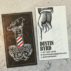 Black and white design on front with a pop of color for the barber pole and then a black and white design on back with contact information.