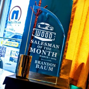 Clear glass plaque from Wood Ford for Salesman of the Month. March 2023 Brandon Baum