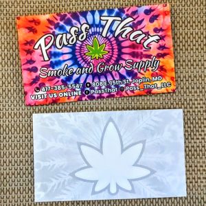Tie die background on front with Pass That and underneath it states Smoke and Grow Supply with contact information. Back as an outline of a cannabis leaf in gray and white.