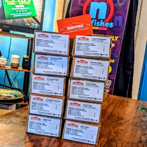 Bulk order business cards. One side has contact information for each person and the back of each card is orange with white writing that states SERVPRO