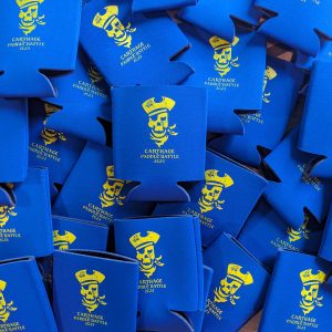 A stack of can koozies with a pirate above the words Carthage Paddle Battle 2023